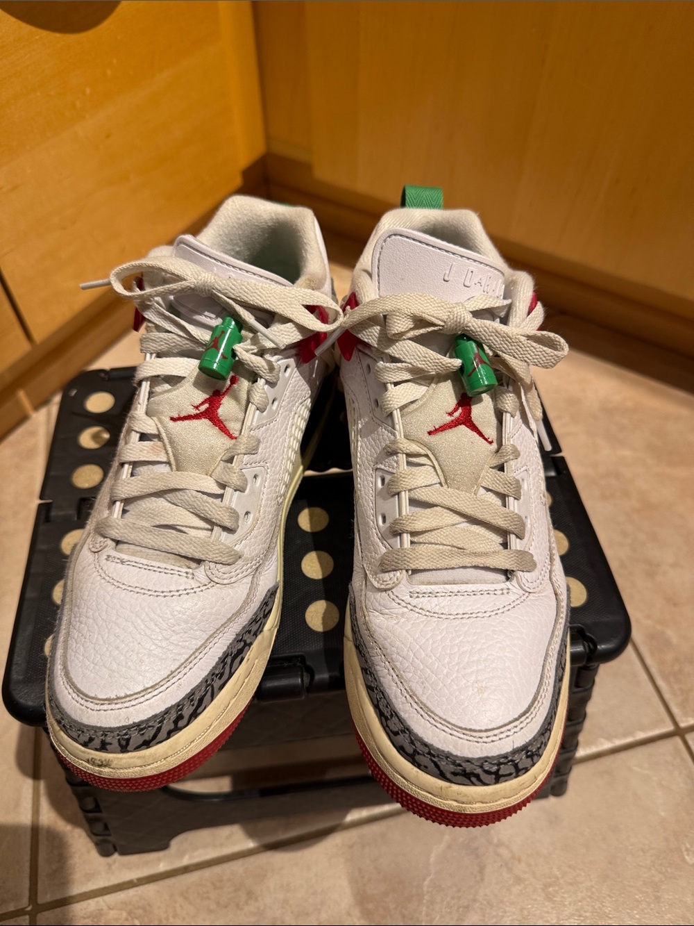 Nike Jordan’s: White Leather Sneakers with Red & Green Accents.